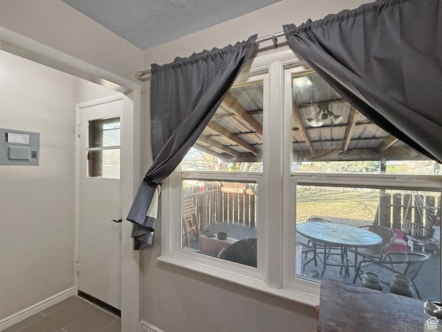 doorway featuring baseboards