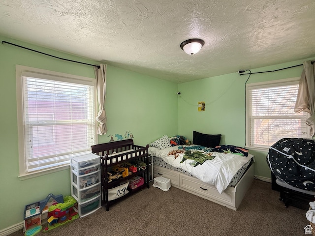 carpeted bedroom featuring a textured ceiling