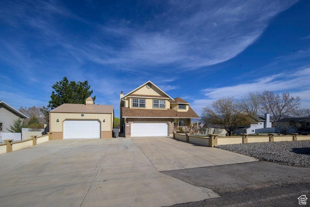 view of front of house featuring driveway and fence