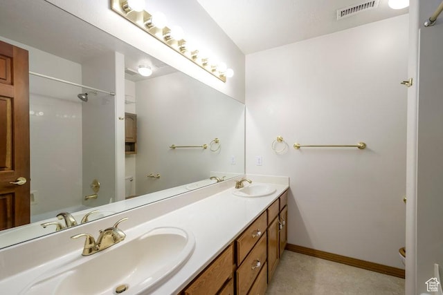 full bathroom with double vanity, toilet, and washtub / shower combination