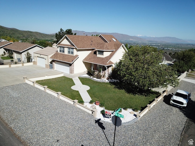 view of front facade with driveway, a mountain view, and a residential view