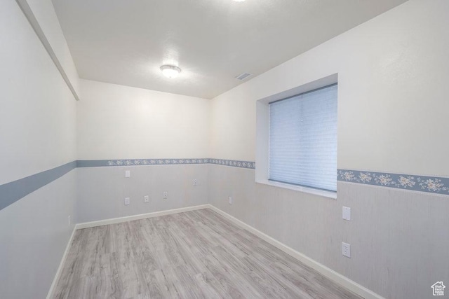 unfurnished room featuring wood finished floors and baseboards