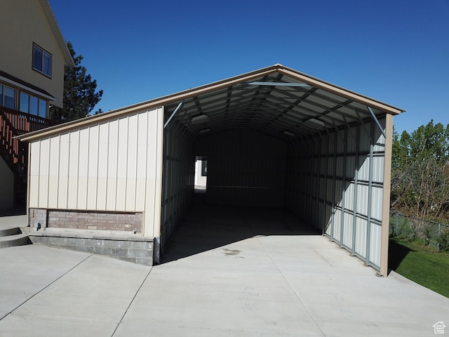 view of outdoor structure featuring a detached carport and concrete driveway