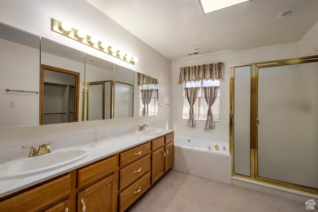 full bath with a stall shower, a garden tub, and double vanity