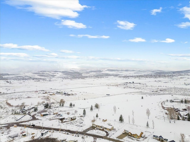 snowy aerial view with a mountain view