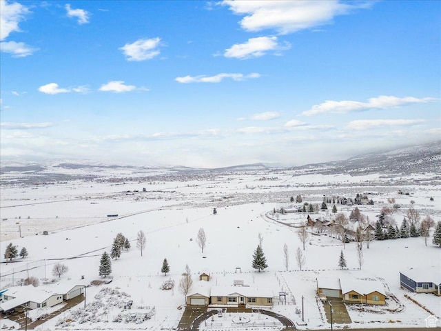snowy aerial view with a mountain view