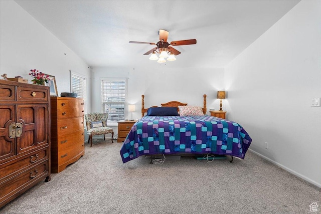 bedroom featuring baseboards, ceiling fan, and light carpet