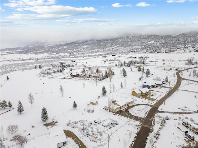 snowy aerial view featuring a mountain view