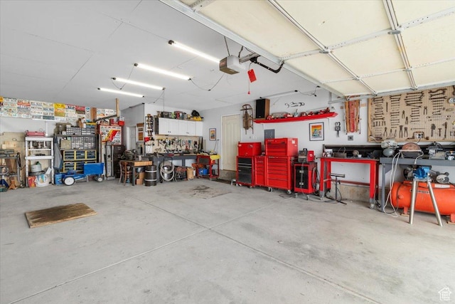 garage featuring a garage door opener and a workshop area