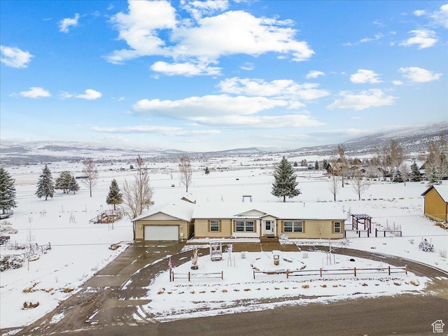 snowy aerial view featuring a mountain view