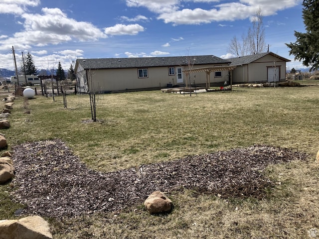 rear view of house featuring a lawn