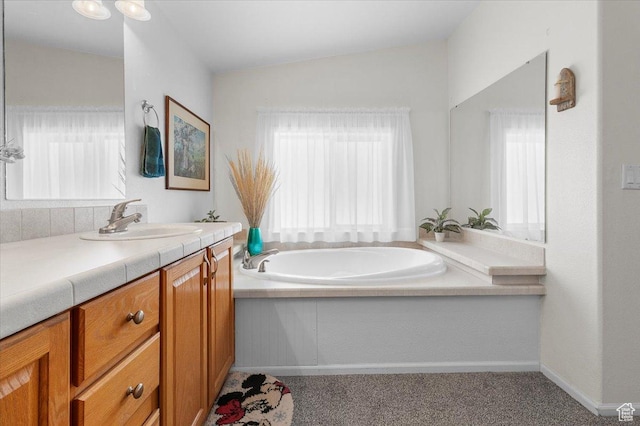 bathroom with baseboards, a bath, vanity, and vaulted ceiling