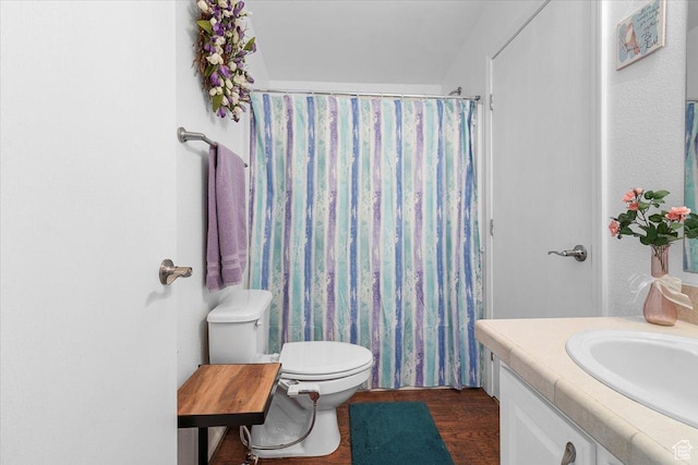 bathroom with a shower with curtain, wood finished floors, toilet, and vanity