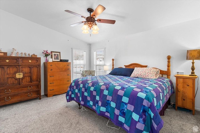 bedroom featuring light colored carpet, a ceiling fan, and vaulted ceiling