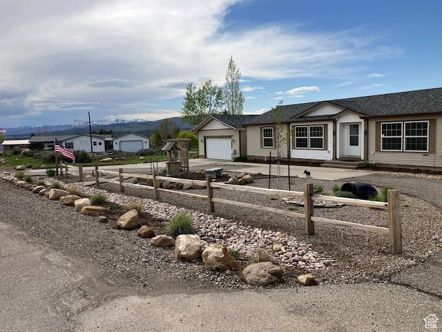 single story home featuring a garage and concrete driveway
