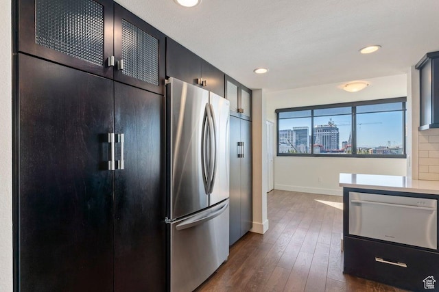 241 N Vine St Unit 606E, Salt Lake City, UT 84103 - kitchen with recessed lighting, baseboards, dark wood finished floors, a city view, and freestanding refrigerator