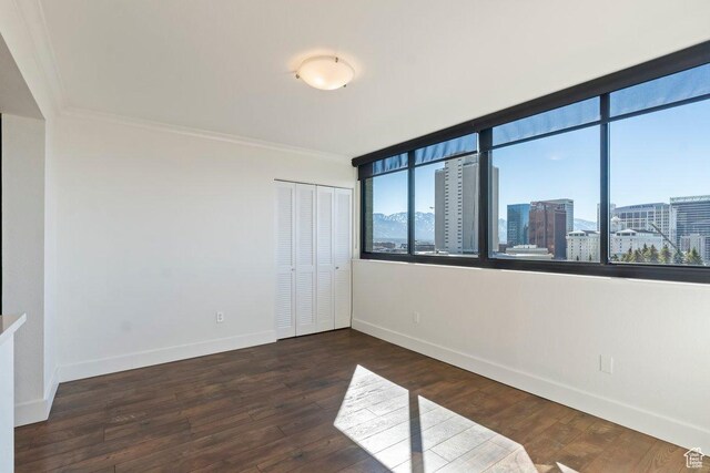 241 N Vine St Unit 606E, Salt Lake City, UT 84103 - unfurnished room with baseboards, a view of city, wood finished floors, and crown molding