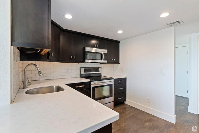 241 N Vine St Unit 606E, Salt Lake City, UT 84103 - kitchen featuring light countertops, backsplash, a sink, stainless steel appliances, and visible vents