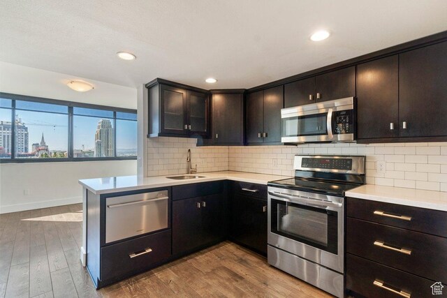 241 N Vine St Unit 606E, Salt Lake City, UT 84103 - kitchen featuring light countertops, a warming drawer, stainless steel appliances, a sink, and a city view