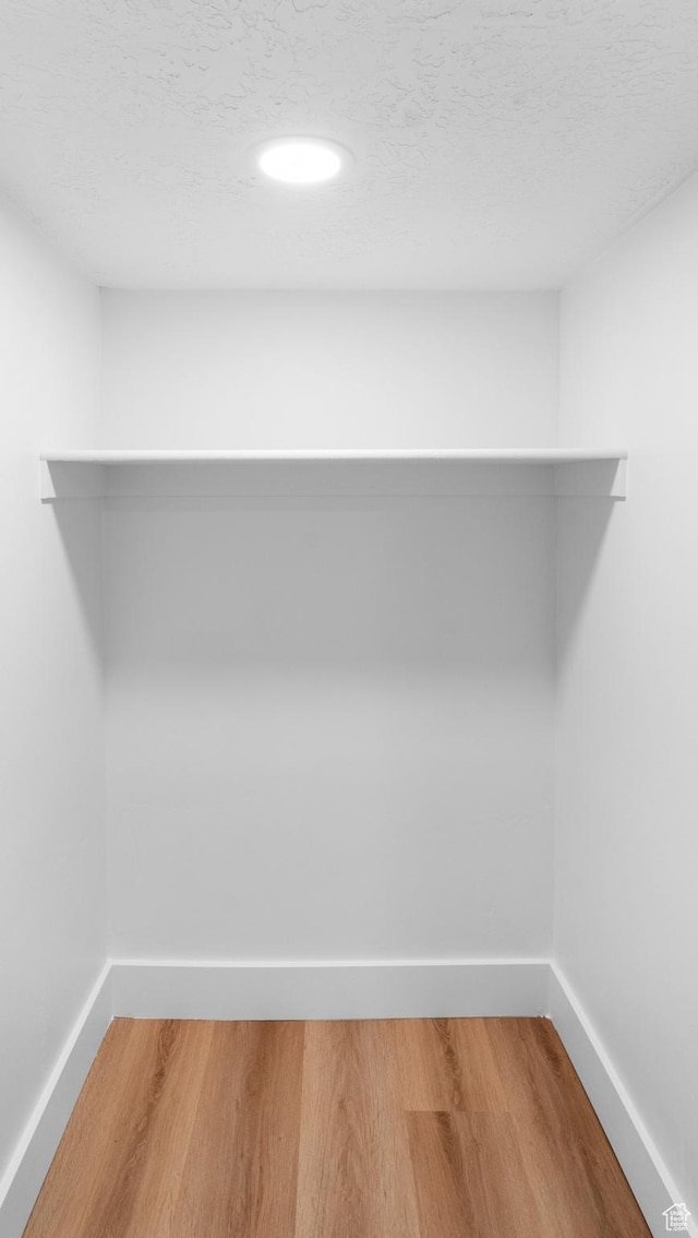 spacious closet with wood finished floors
