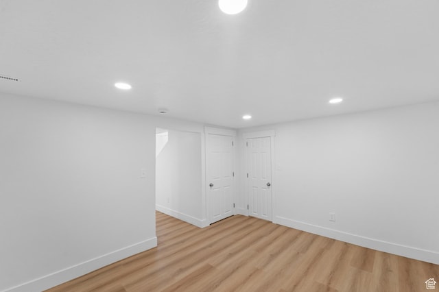 finished basement with baseboards, light wood finished floors, and recessed lighting