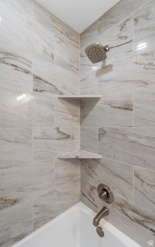 bathroom with bathing tub / shower combination