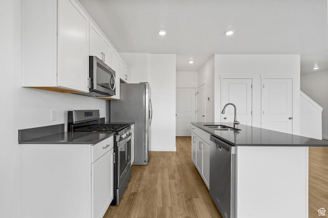 866 S Brubaker Way, Santaquin, UT 84655 - kitchen featuring appliances with stainless steel finishes, dark countertops, light wood-type flooring, white cabinets, and recessed lighting