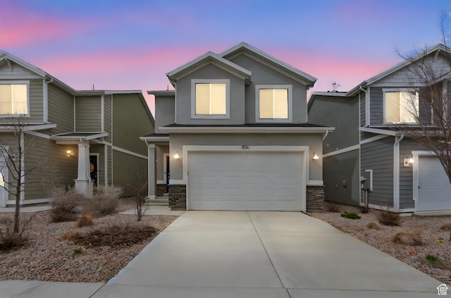866 S Brubaker Way, Santaquin, UT 84655 - view of front of house with a garage, driveway, stucco siding, and stone siding