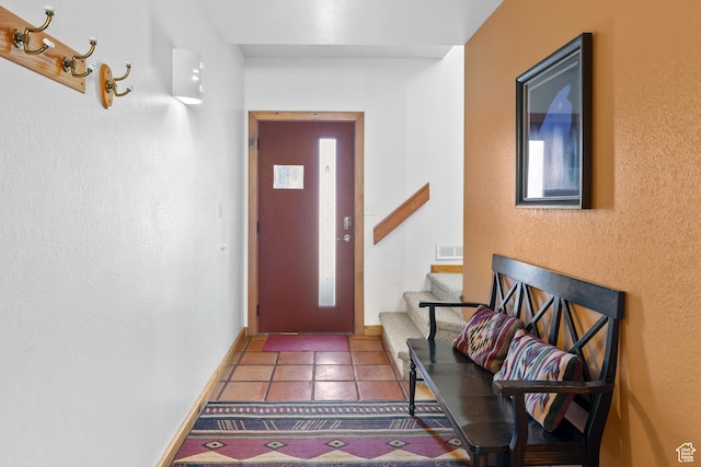 3418 E La Camino, Moab, UT 84532 - doorway to outside with baseboards, visible vents, tile patterned floors, and stairway