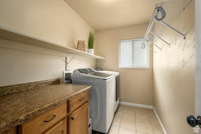laundry room featuring independent washer and dryer, laundry area, light tile patterned floors, and baseboards