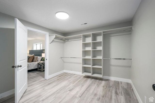 spacious closet with visible vents and light wood-style flooring