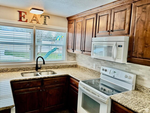 23 W 100 S, Payson, UT 84651 - kitchen with a sink, light stone countertops, a textured ceiling, white appliances, and decorative backsplash