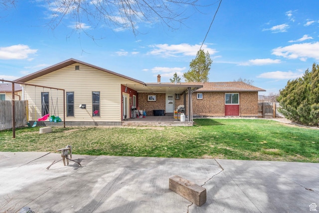 270 N 100 W, Goshen, UT 84633 - rear view of house with brick siding, a lawn, fence, and a patio