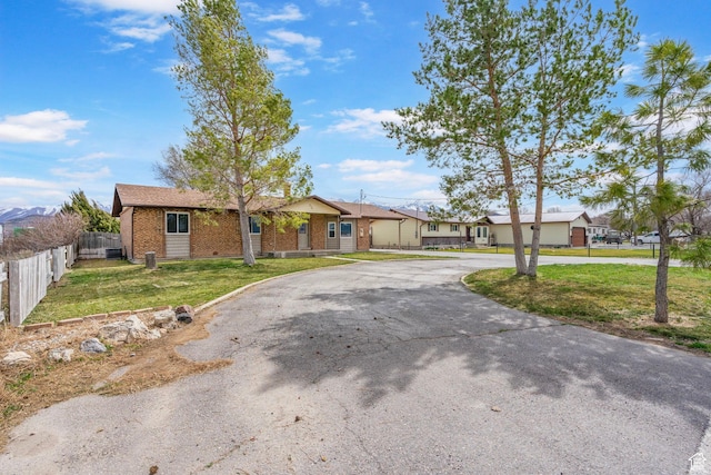 270 N 100 W, Goshen, UT 84633 - single story home with brick siding, a front yard, curved driveway, and fence