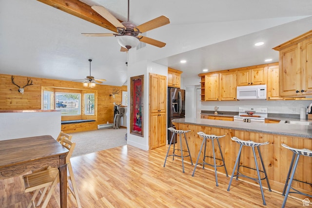 270 N 100 W, Goshen, UT 84633 - kitchen featuring a peninsula, wooden walls, white appliances, ceiling fan, and lofted ceiling