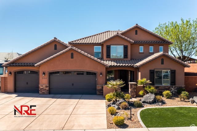 mediterranean / spanish home featuring a garage, stone siding, stucco siding, a tiled roof, and driveway