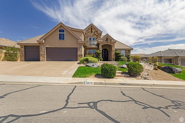 428 N Northstar Dr, St George, UT 84770 - traditional-style home with concrete driveway, stucco siding, a tile roof, stone siding, and a garage