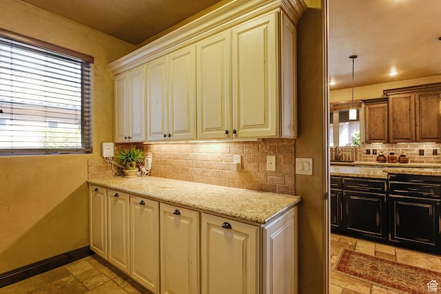 428 N Northstar Dr, St George, UT 84770 - kitchen featuring stone tile floors, tasteful backsplash, light stone counters, and plenty of natural light