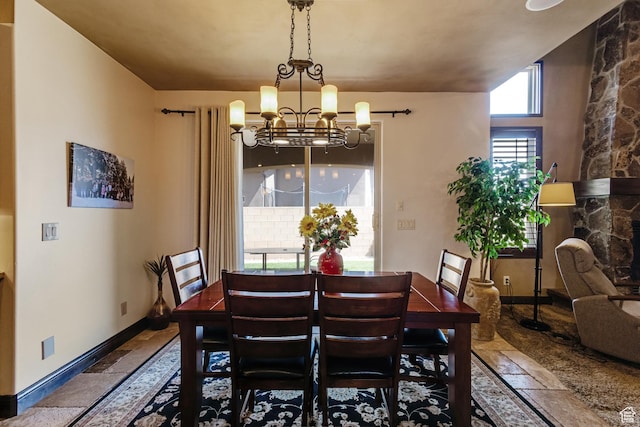 428 N Northstar Dr, St George, UT 84770 - dining area featuring stone tile floors, baseboards, and a chandelier