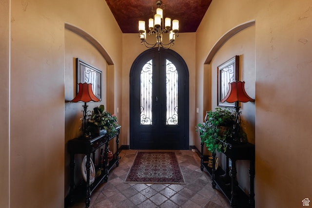 428 N Northstar Dr, St George, UT 84770 - foyer featuring stone tile floors, french doors, arched walkways, and a chandelier