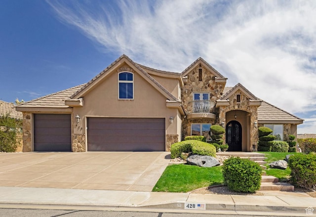 428 N Northstar Dr, St George, UT 84770 - view of front of house with stucco siding, an attached garage, stone siding, and a balcony