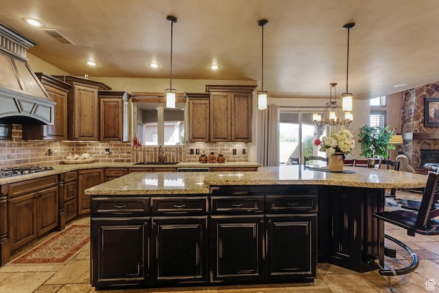 428 N Northstar Dr, St George, UT 84770 - kitchen featuring dark cabinetry, a sink, gas cooktop, a kitchen island, and decorative backsplash