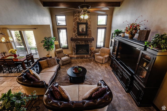 428 N Northstar Dr, St George, UT 84770 - carpeted living room with beamed ceiling, a stone fireplace, a high ceiling, and a ceiling fan