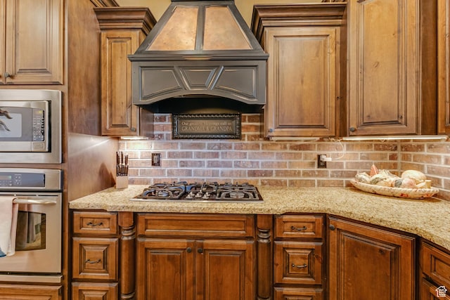 428 N Northstar Dr, St George, UT 84770 - kitchen with light stone countertops, custom exhaust hood, backsplash, and appliances with stainless steel finishes