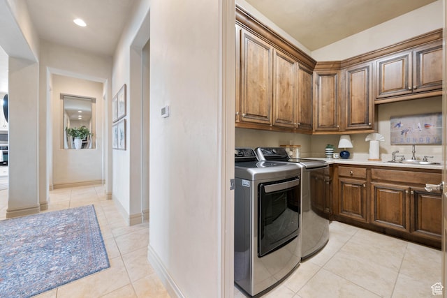 2653 Rio Lobo Dr, St George, UT 84770 - washroom with independent washer and dryer, light tile patterned floors, baseboards, a sink, and cabinet space