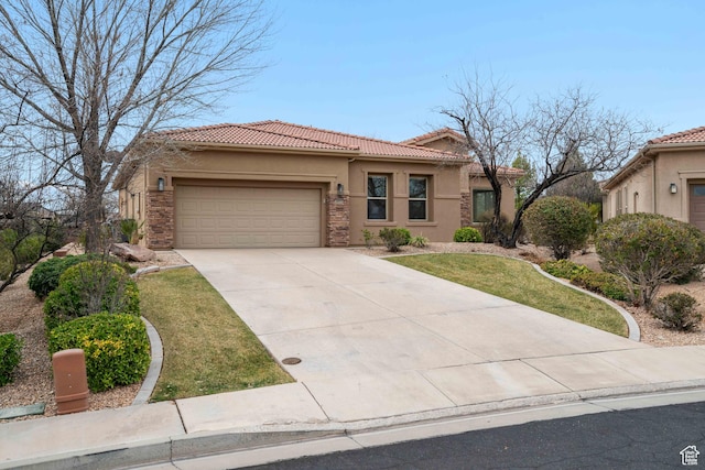 2653 Rio Lobo Dr, St George, UT 84770 - mediterranean / spanish-style home featuring a front yard, concrete driveway, stucco siding, an attached garage, and a tiled roof