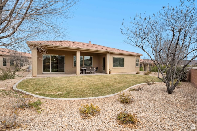 2653 Rio Lobo Dr, St George, UT 84770 - rear view of property featuring a patio, a tiled roof, a lawn, and stucco siding