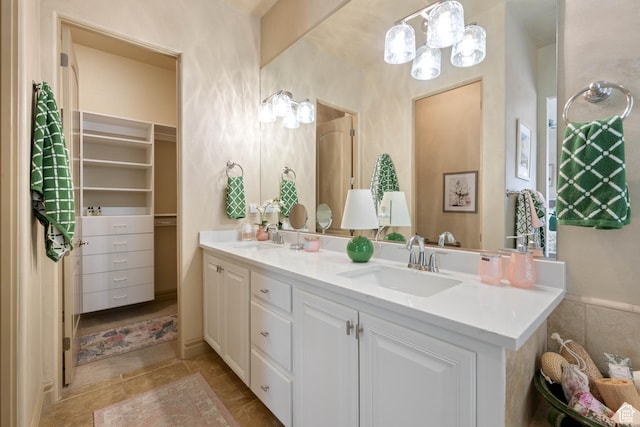2653 Rio Lobo Dr, St George, UT 84770 - bathroom with a spacious closet, double vanity, a sink, and a chandelier