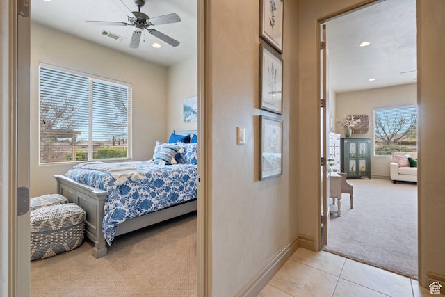 2653 Rio Lobo Dr, St George, UT 84770 - bedroom featuring light tile patterned flooring, visible vents, recessed lighting, and light carpet