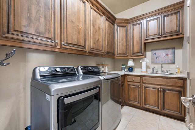 2653 Rio Lobo Dr, St George, UT 84770 - laundry area with light tile patterned floors, cabinet space, a sink, and washer and dryer